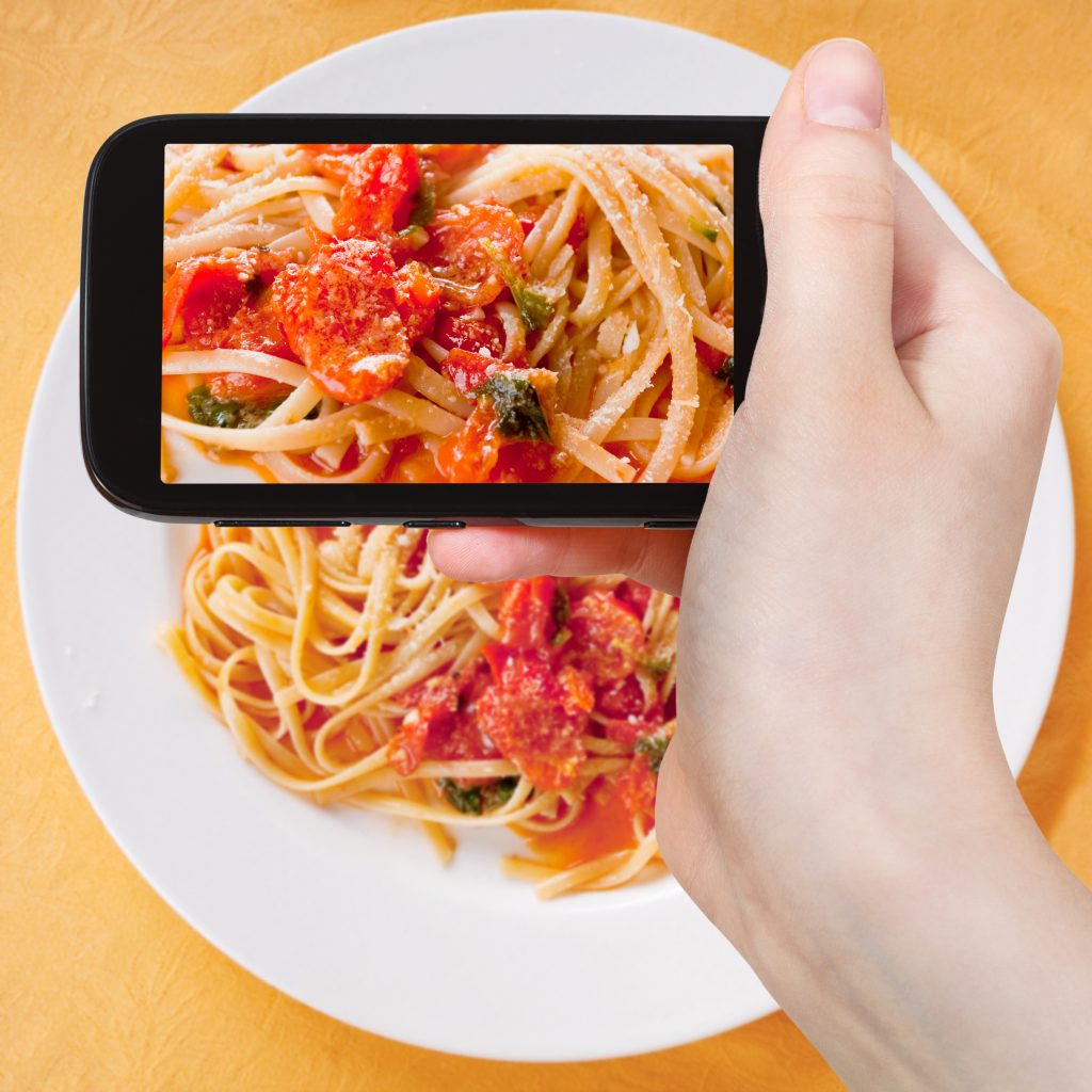 food blogger holding phone 