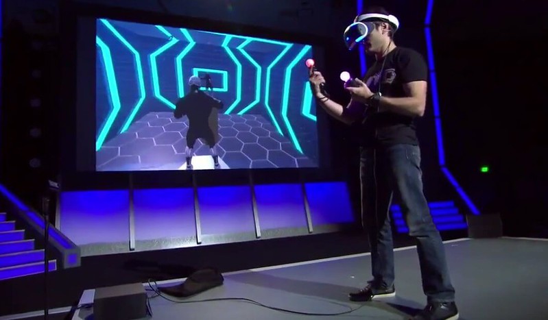 man using virtual reality gear with screen beside him as one of the most popular marketing trends