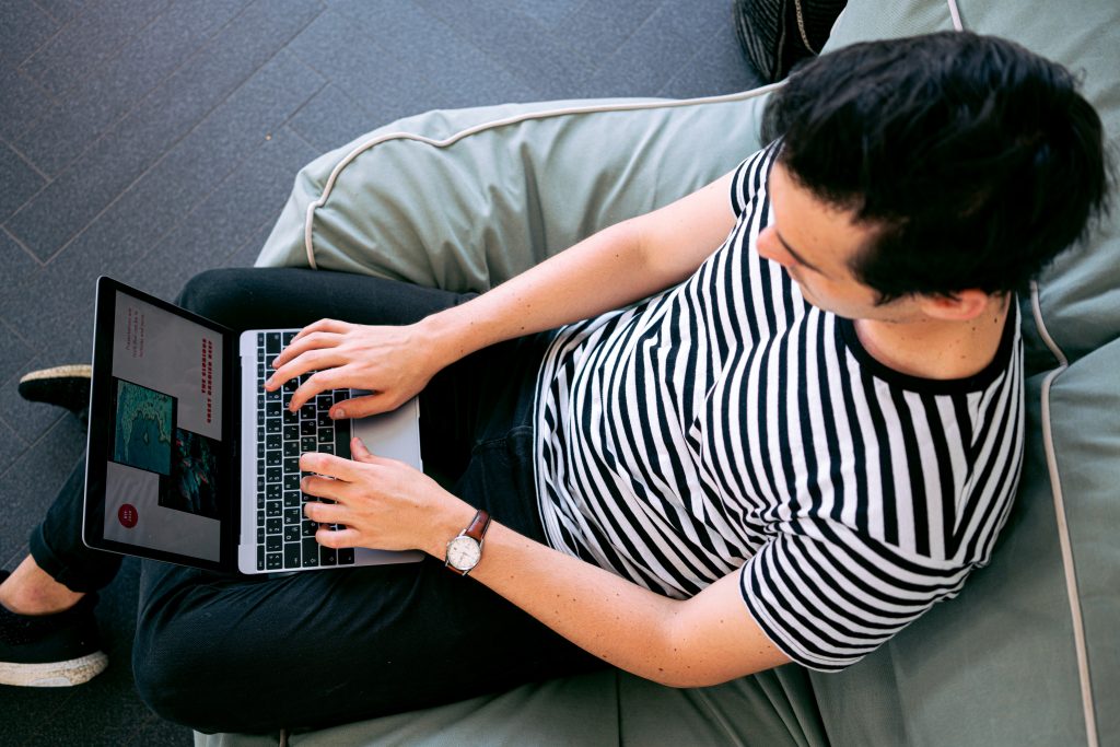 person viewing a laptop screen to analyze it for redesigning websites