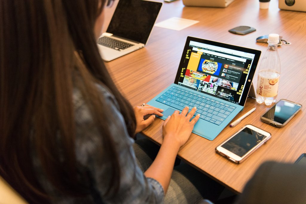virtual assistant sitting down and using a laptop