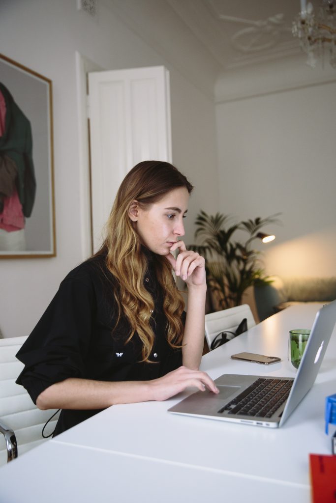 developer part of web development team thinking in front of laptop on table