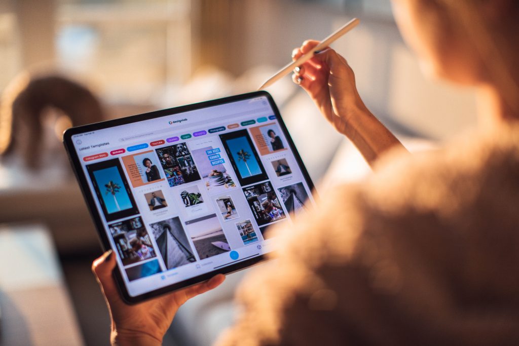 person holding digital tablet 