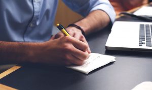 person taking notes for branding a business