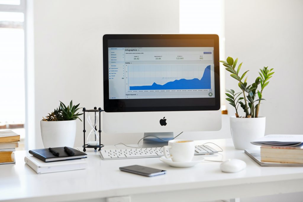 marketing company office desktop with coffee and plants