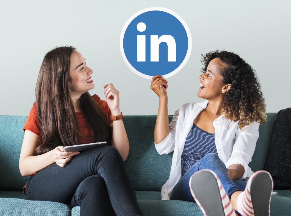 Two Women Holding LinkedIn Logo